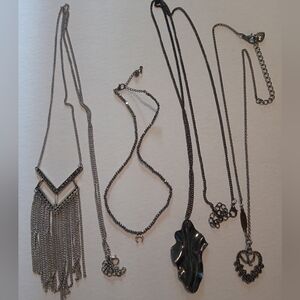 #409.   4 Piece Assorted Silver Toned Necklace Bundle